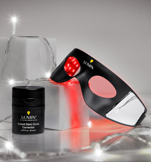 Red light therapy device with black LED treatment mask and Lanin CBD recovery cream jar on white surface with fairy lights