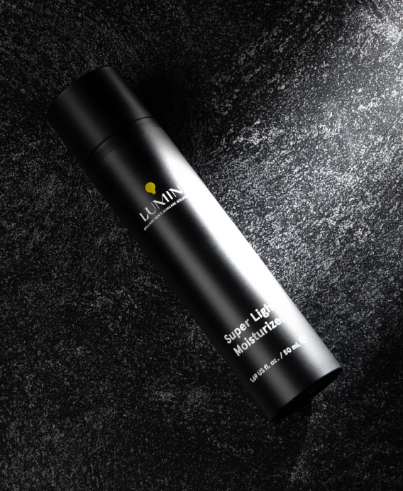 Luxury black skincare serum bottle with gold logo on textured dark background, anti-aging face treatment product
