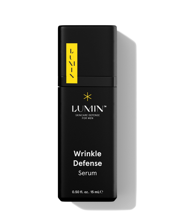 Close-up of Lumin Wrinkle Defense Serum for men, featuring sleek black packaging and skincare branding.