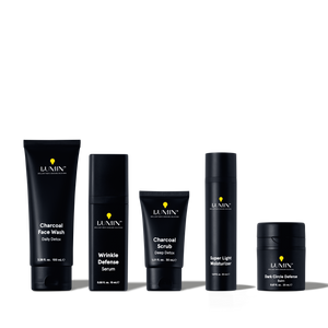 Lumin men's skincare set featuring charcoal face wash, wrinkle defense serum, charcoal scrub, super light moisturizer, and dark circle balm