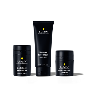 Lumin men's skincare set with charcoal face wash, daily face moisturizer, and instant dark circle corrector in black packaging