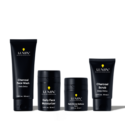 Lumin men's skincare set with Charcoal Face Wash, Daily Face Moisturizer, Dark Circle Defense Balm, and Charcoal Scrub.
