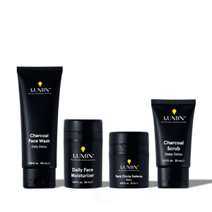 Lumin men's skincare set with Charcoal Face Wash, Daily Face Moisturizer, Dark Circle Defense Balm, and Charcoal Scrub.