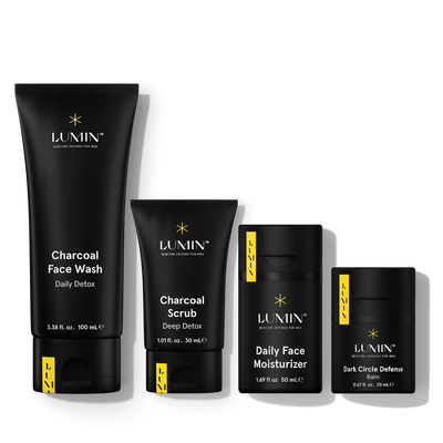 Lumin men's skincare set with charcoal face wash, charcoal scrub, daily moisturizer, and dark circle defense balm.