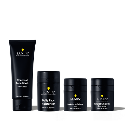 Lumin men's skincare set including charcoal face wash, daily face moisturizer, dark circle defense balm, and instant dark circle corrector.