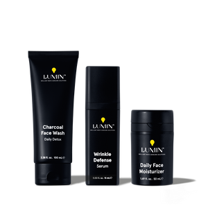 Lumin men's skincare set with Charcoal Face Wash, Wrinkle Defense Serum, and Daily Face Moisturizer in black packaging