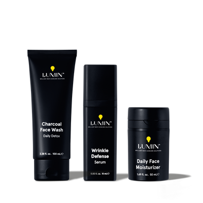 Lumin men's skincare set with Charcoal Face Wash, Wrinkle Defense Serum, and Daily Face Moisturizer in black packaging